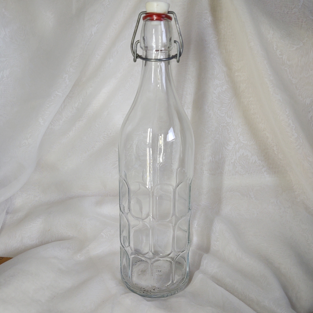 Clear Glass Bottle with Red Swing Top